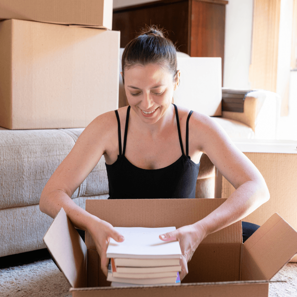 a customer packing her books to be donated to charity. 