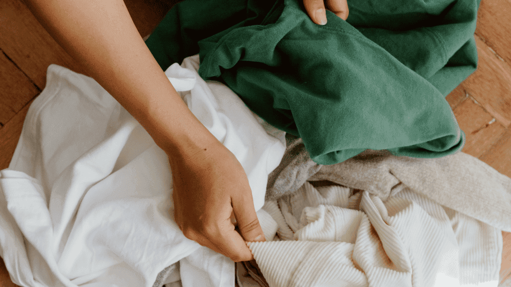 Woman folding clothes ready to donate.