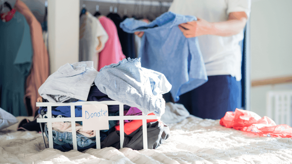 Woman packing up clothes for donation in Guildford