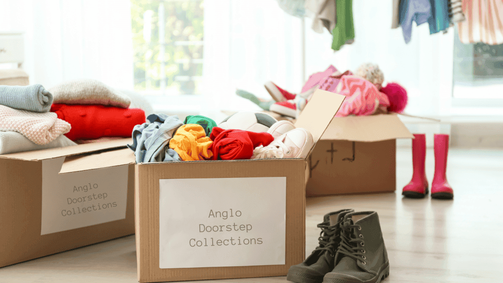 Clothes and shoes in boxes ready to be donated.