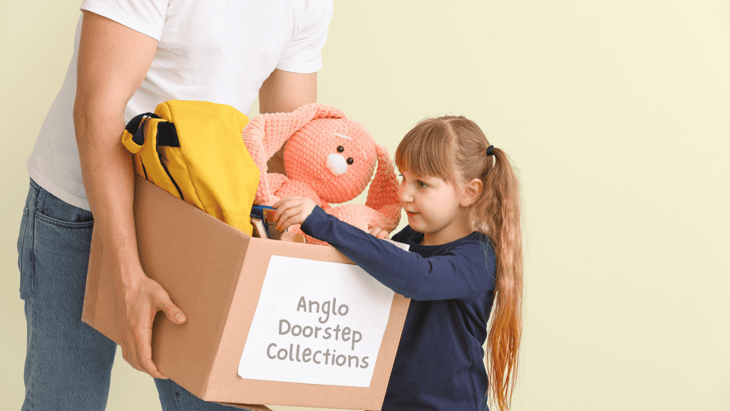 Daughter and Dad packing up toys into a box ready to donate.