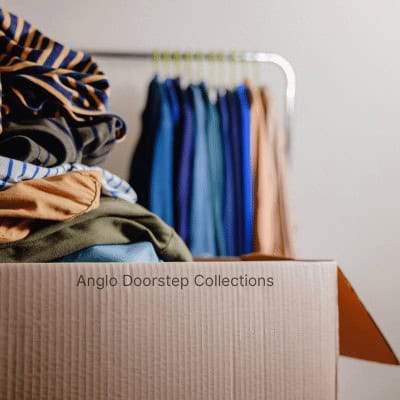 Box filled with clothes, box is labelled 'anglo doorstep collections' 