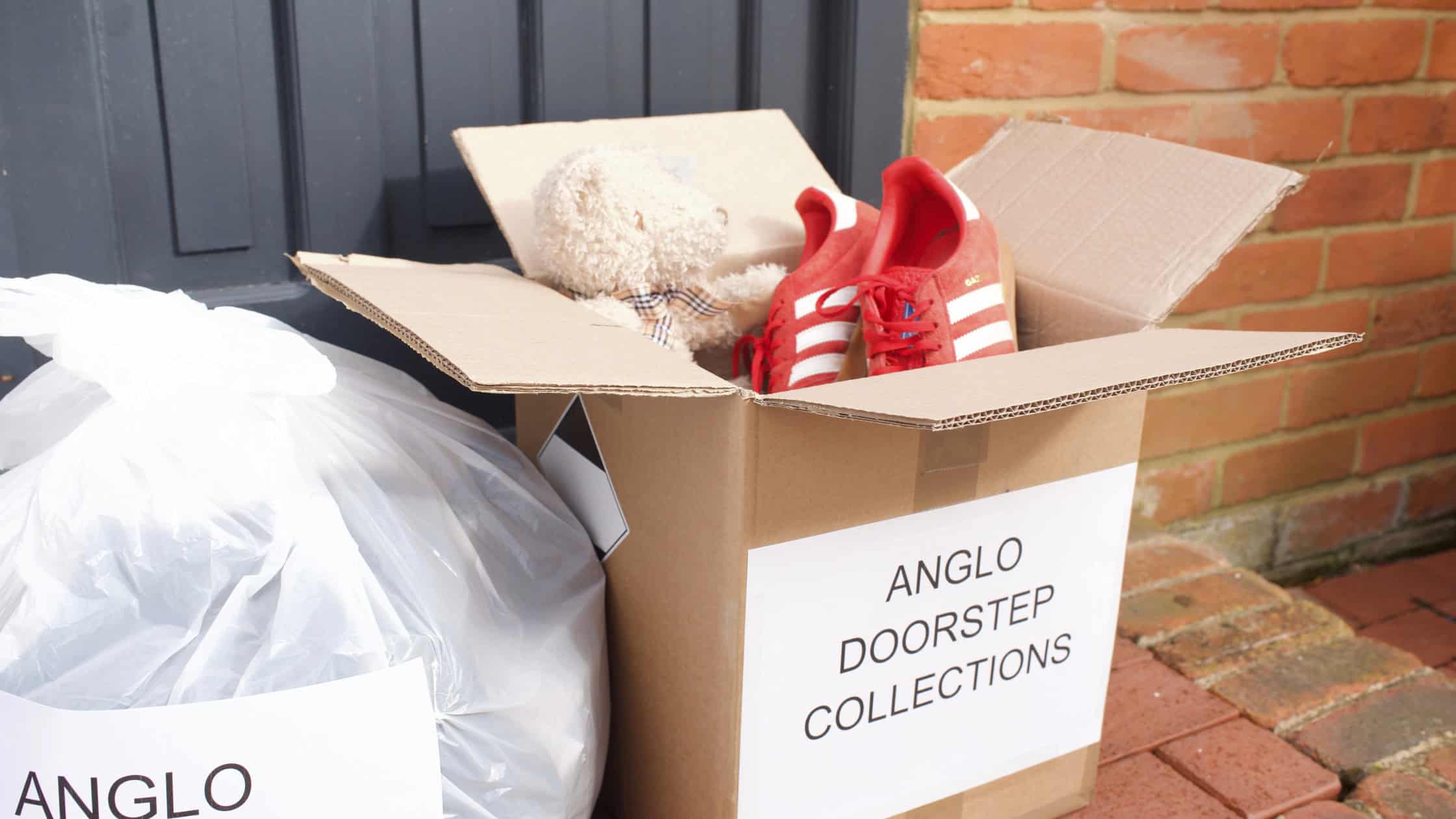 clothing donations in bag and box on doorstep.