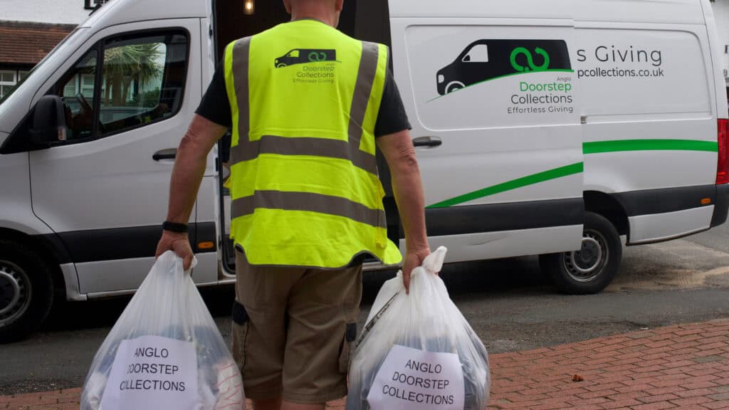 Anglo doorstep collections driver collecting donations, walking to the van.